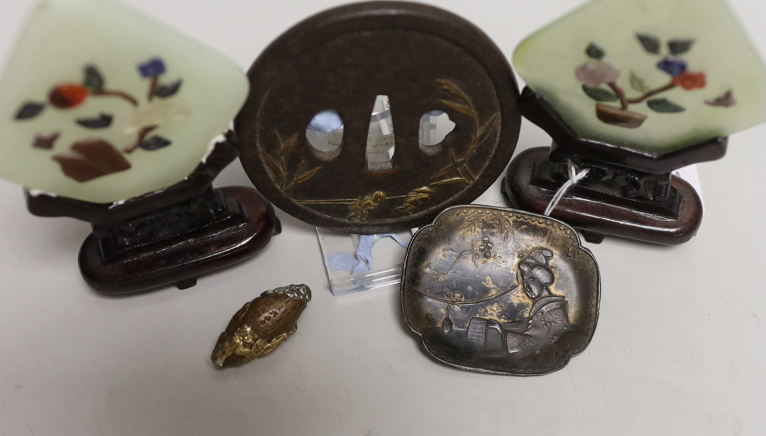 A pair of Chinese bowenite miniature table screens on hardwood stands, 12cm, a gilt cast iron Japanese tsuba, gilt bronze ojime and pin dish